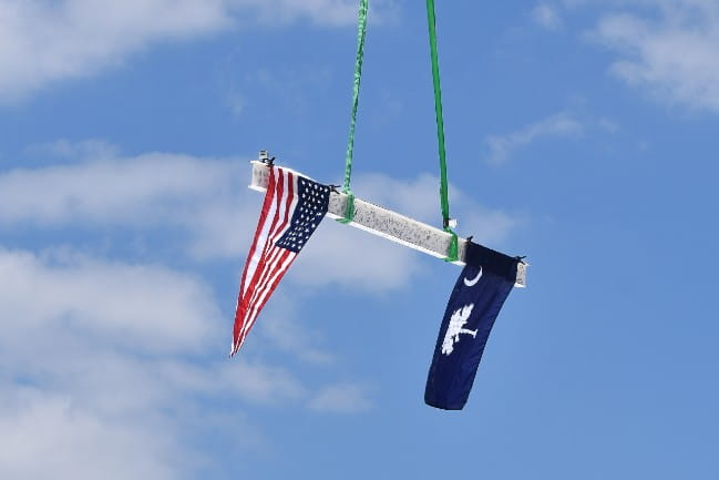 An steel beam with the American flag and the Palmetto flag placed atop the new Hugh K. Leatherman Behavioral Health Pavilion in Florence, SC.