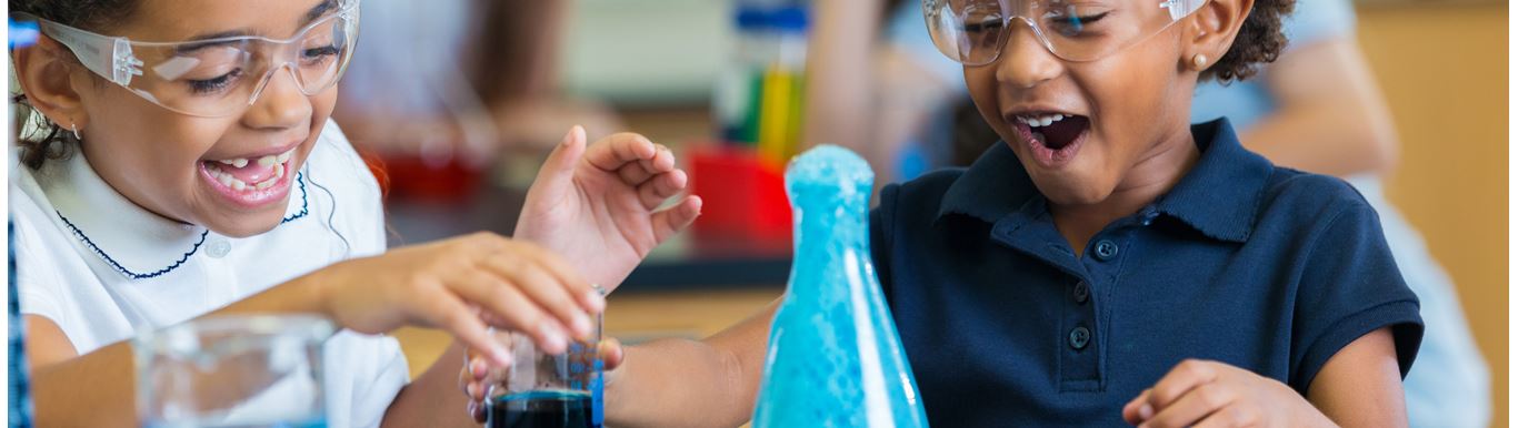Two young girls excited about a science project